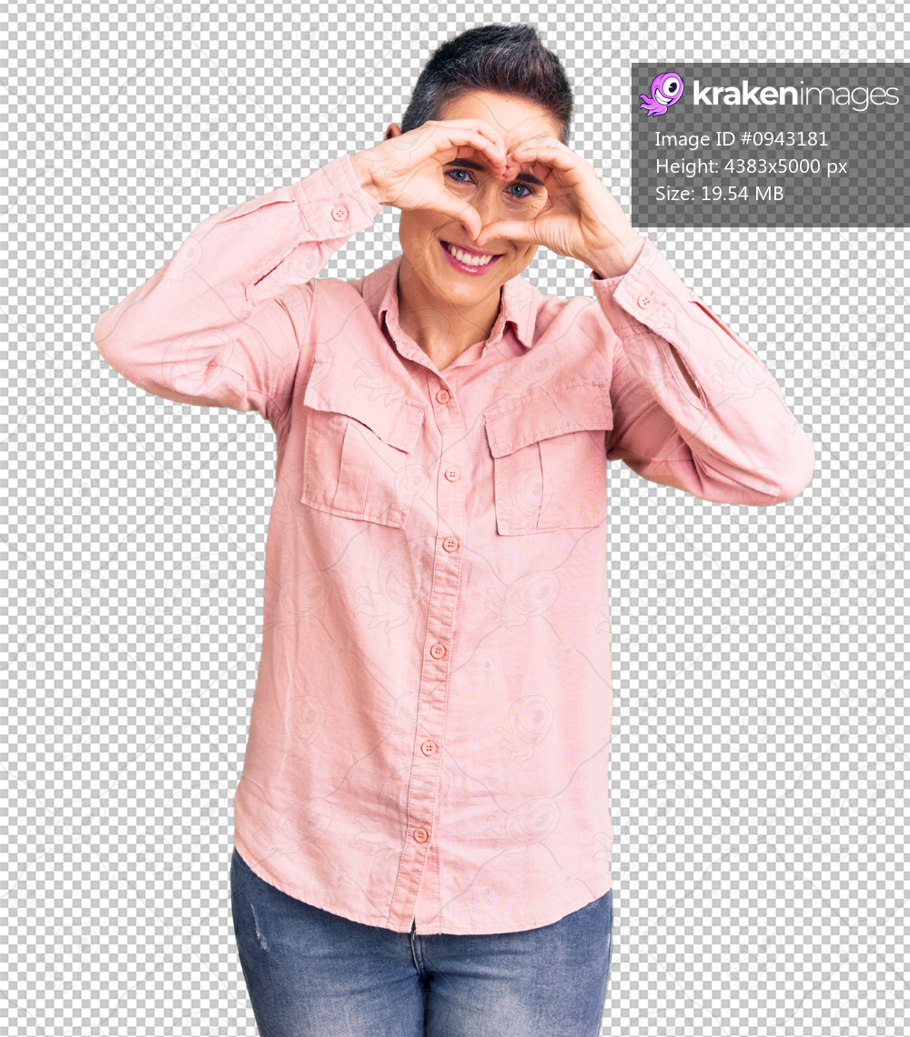 Young woman with short hair wearing casual clothes doing heart shape with hand and fingers smiling looking through sign