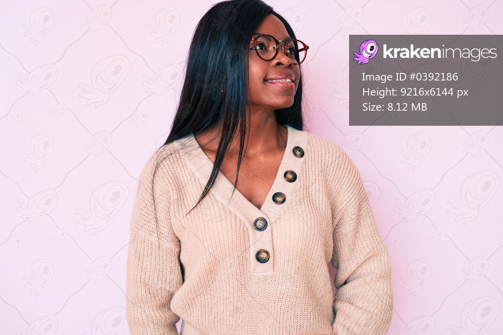 Young african american woman wearing casual clothes looking to side, relax profile pose with natural face and confident smile. 
