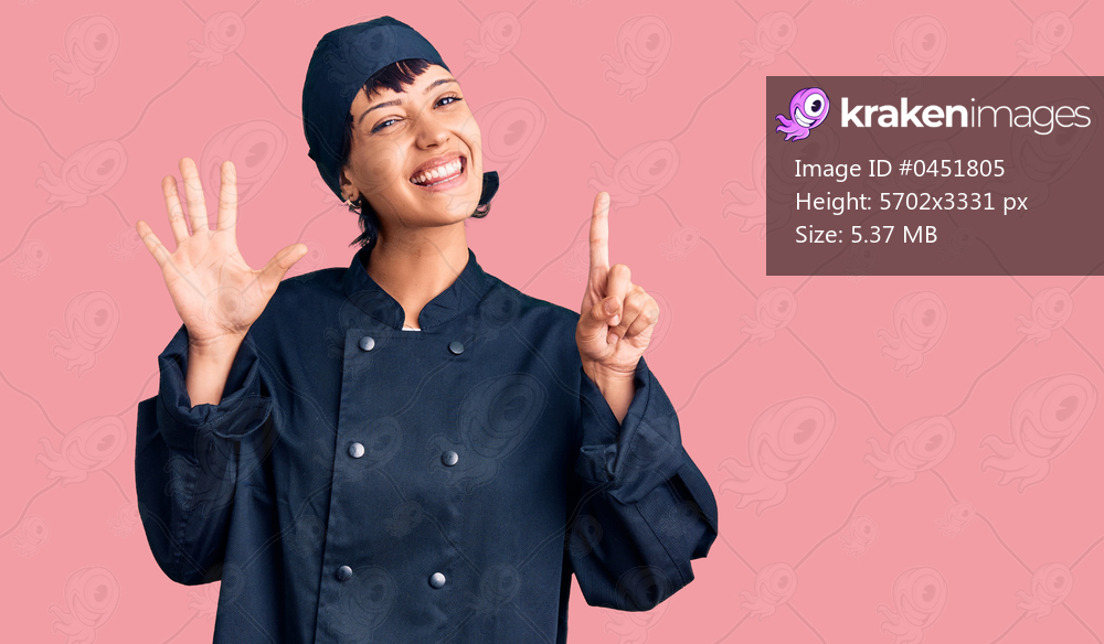 Young brunette woman with short hair wearing professional cook uniform showing and pointing up with fingers number six while smiling confident and happy. 