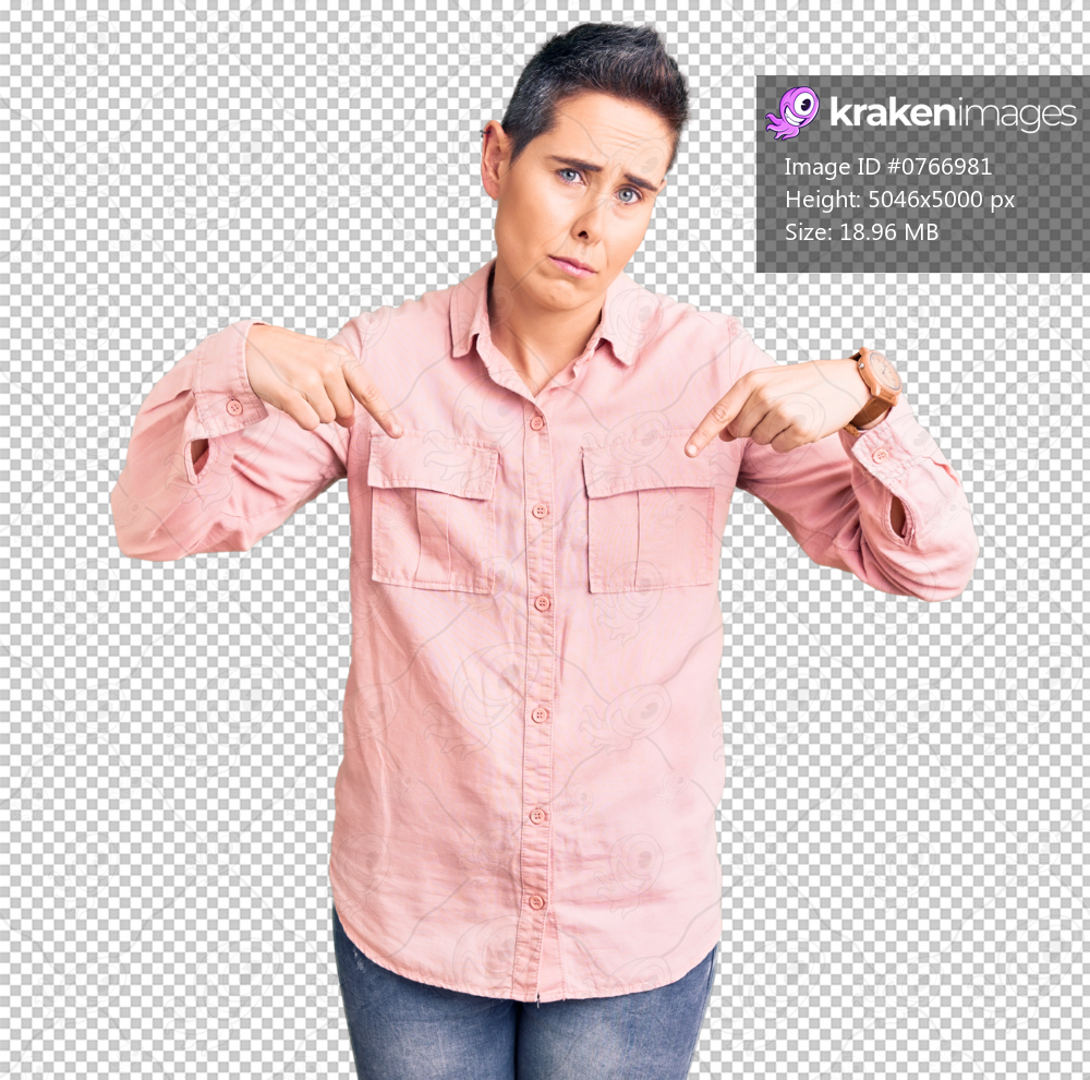 Young woman with short hair wearing casual clothes pointing down looking sad and upset, indicating direction with fingers, unhappy and depressed.