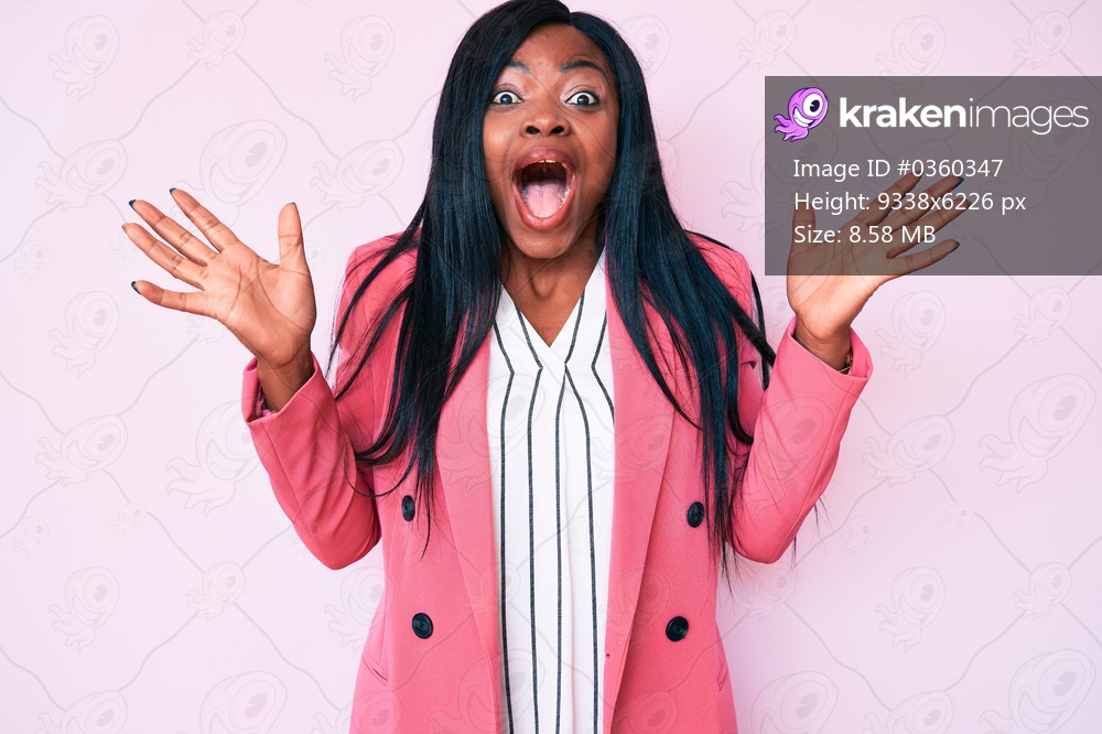Young african american woman wearing business clothes celebrating crazy and amazed for success with arms raised and open eyes screaming excited. winner concept 