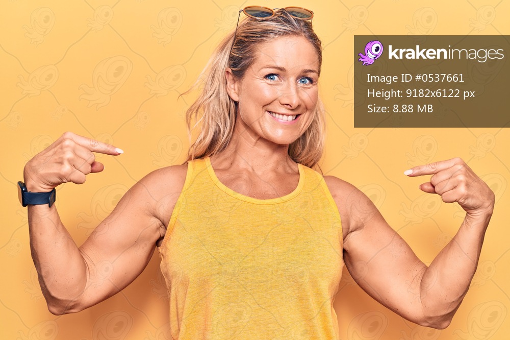 Middle age caucasian blonde woman wearing casual summer clothes and sunglasses looking confident with smile on face, pointing oneself with fingers proud and happy. 