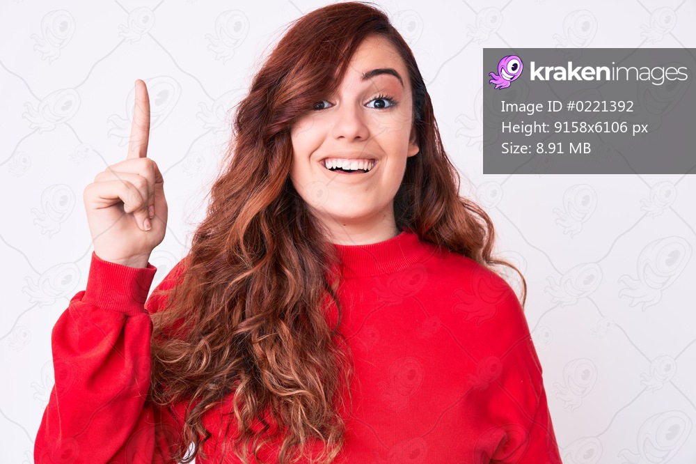Young beautiful woman wearing casual clothes pointing finger up with successful idea. exited and happy. number one. 