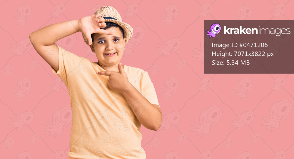 Little boy kid wearing summer hat and hawaiian swimsuit smiling making frame with hands and fingers with happy face. creativity and photography concept. 