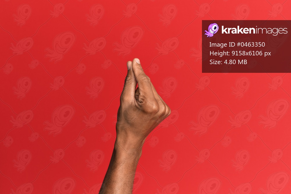 Hand of hispanic man over red isolated background holding blank space with thumb finger, business and advertising 