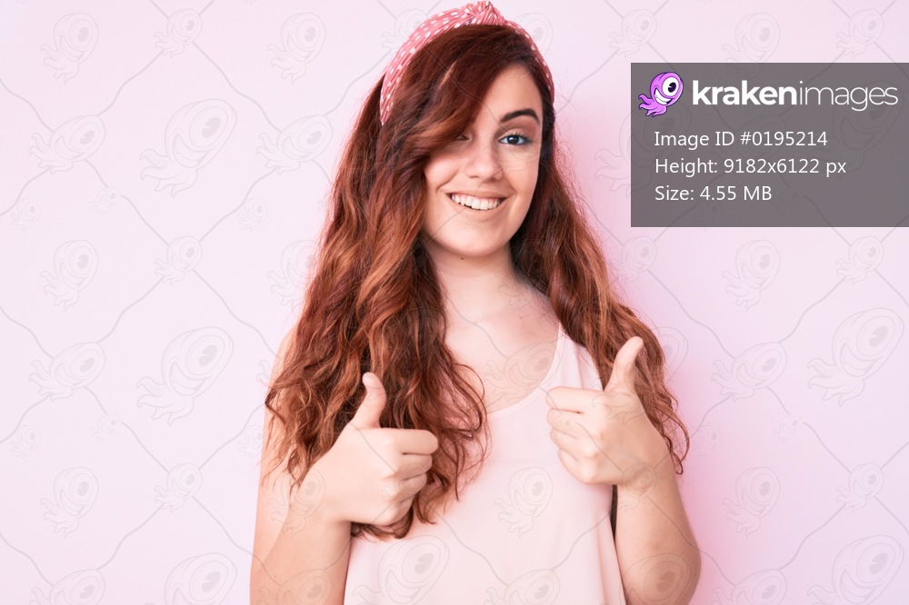 Young beautiful woman wearing casual clothes success sign doing positive gesture with hand, thumbs up smiling and happy. cheerful expression and winner gesture. 
