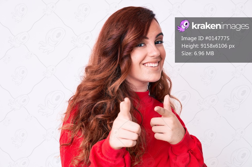 Young beautiful woman wearing casual clothes pointing fingers to camera with happy and funny face. good energy and vibes. 