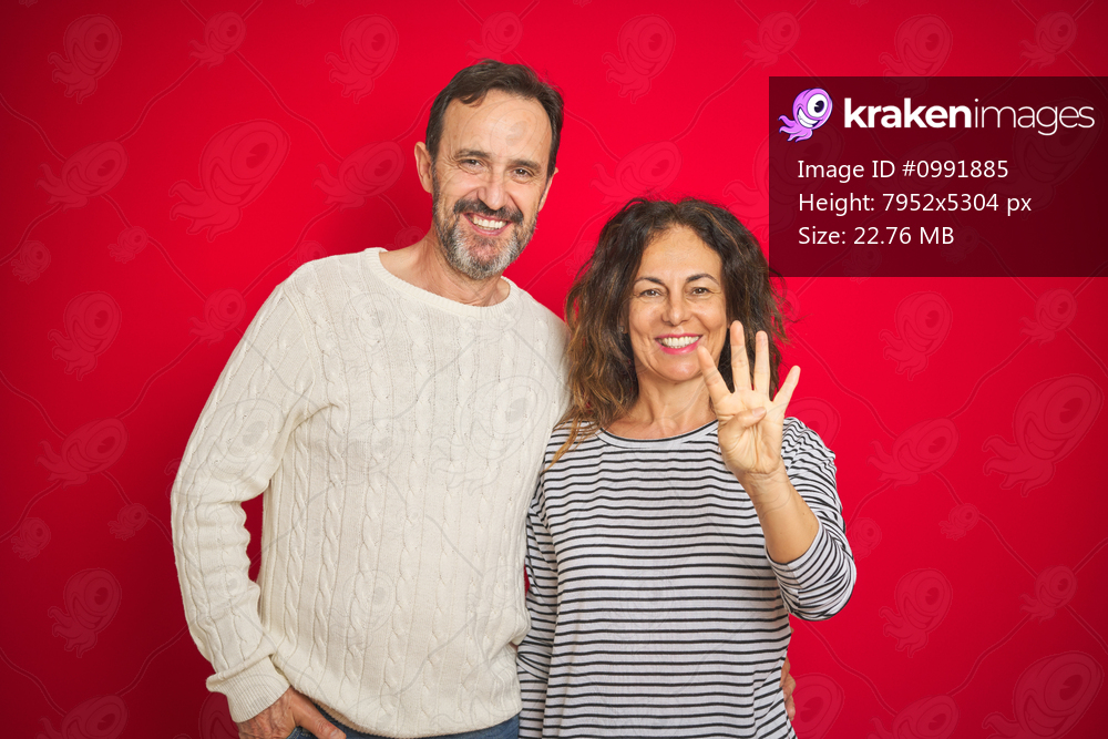 Beautiful middle age couple wearing winter sweater over isolated red background showing and pointing up with fingers number four while smiling confident and happy.
