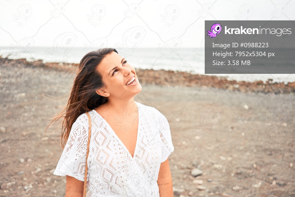Young beautiful woman smiling happy enjoying summer vacation at black sand beach at Canary Islands