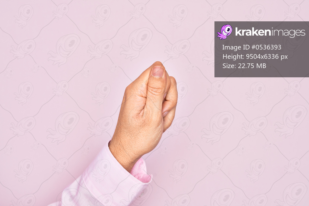 Hand of caucasian young man showing fingers over isolated pink background holding blank space with thumb finger, business and advertising