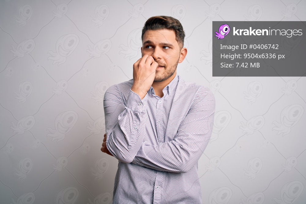 Young business man with blue eyes standing over isolated background looking stressed and nervous with hands on mouth biting nails. Anxiety problem.