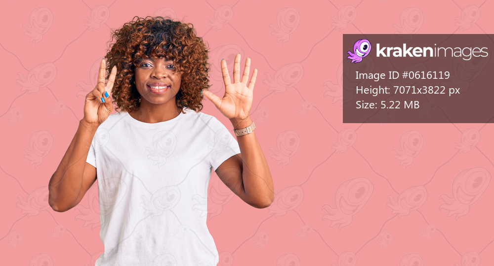 Young african american woman wearing casual white tshirt showing and pointing up with fingers number seven while smiling confident and happy. 