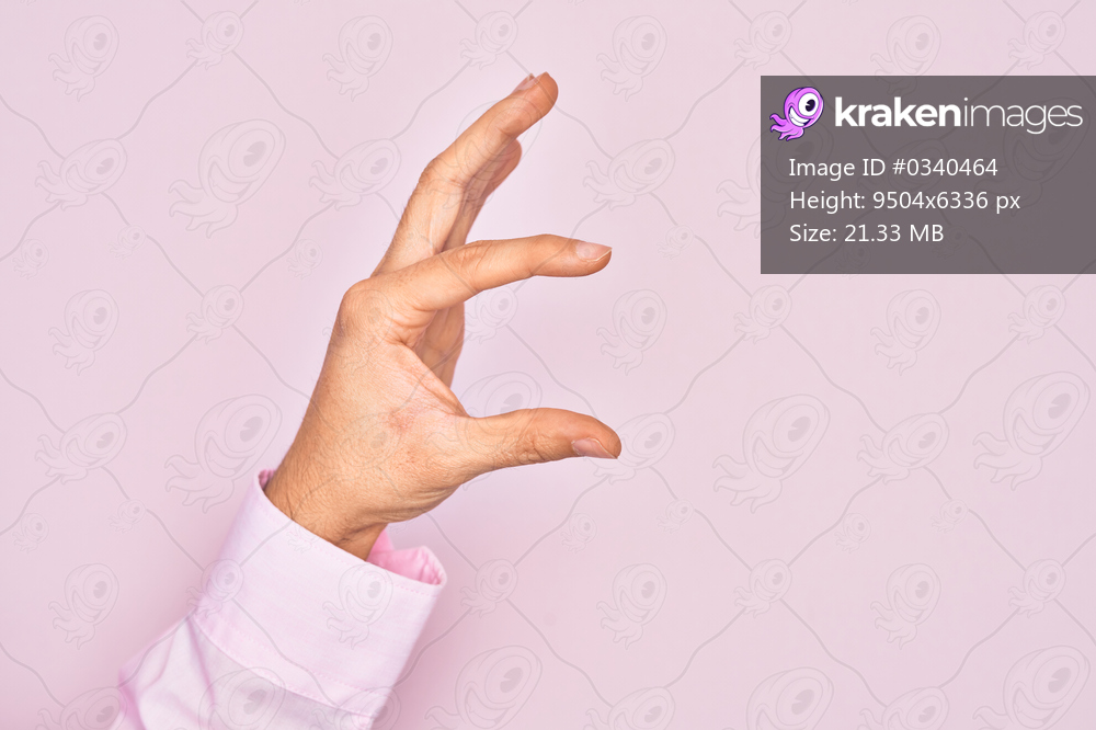 Hand of caucasian young man showing fingers over isolated pink background picking and taking invisible thing, holding object with fingers showing space
