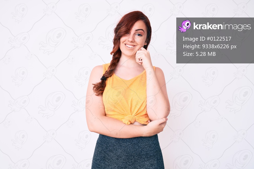 Young beautiful woman wearing casual clothes smiling looking confident at the camera with crossed arms and hand on chin. thinking positive. 