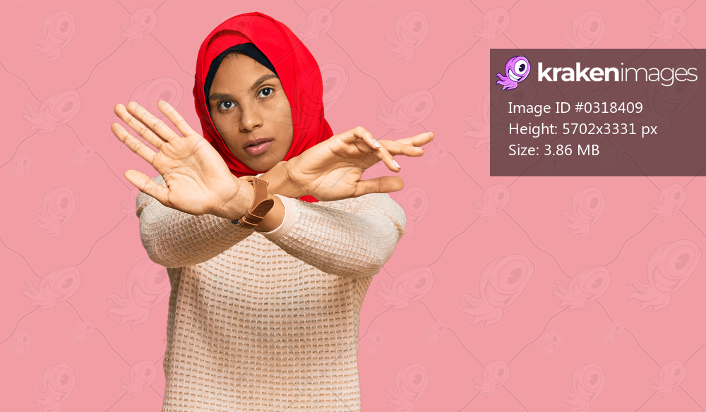 Young african american woman wearing traditional islamic hijab scarf rejection expression crossing arms and palms doing negative sign, angry face 
