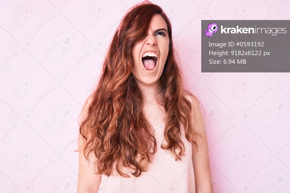 Young beautiful woman wearing casual clothes angry and mad screaming frustrated and furious, shouting with anger. rage and aggressive concept. 