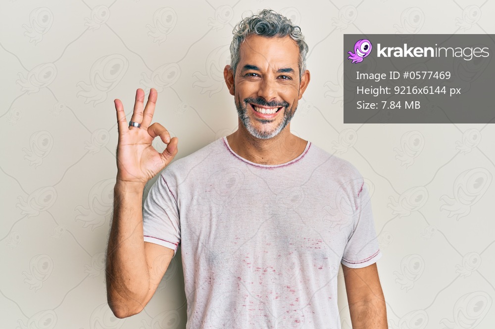 Middle age grey-haired man wearing casual clothes smiling positive doing ok sign with hand and fingers. successful expression. 