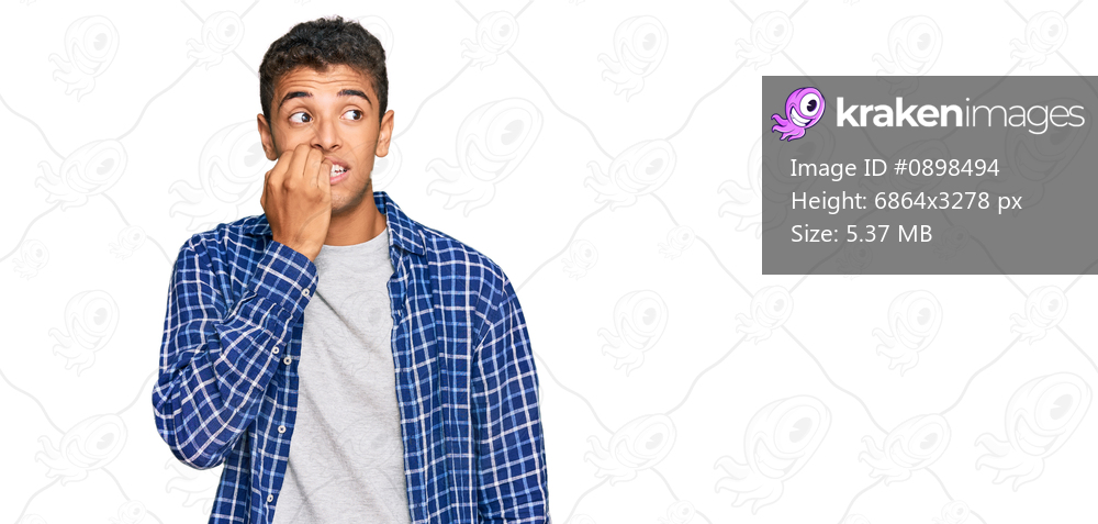 Young handsome african american man wearing casual clothes looking stressed and nervous with hands on mouth biting nails. anxiety problem. 