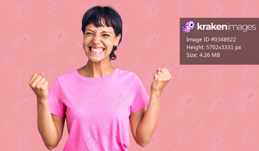 Young brunette woman with short hair wearing casual clothes celebrating surprised and amazed for success with arms raised and open eyes. winner concept. 