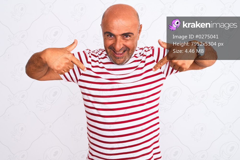 Middle age handsome man wearing striped t-shirt standing over isolated white background looking confident with smile on face, pointing oneself with fingers proud and happy.