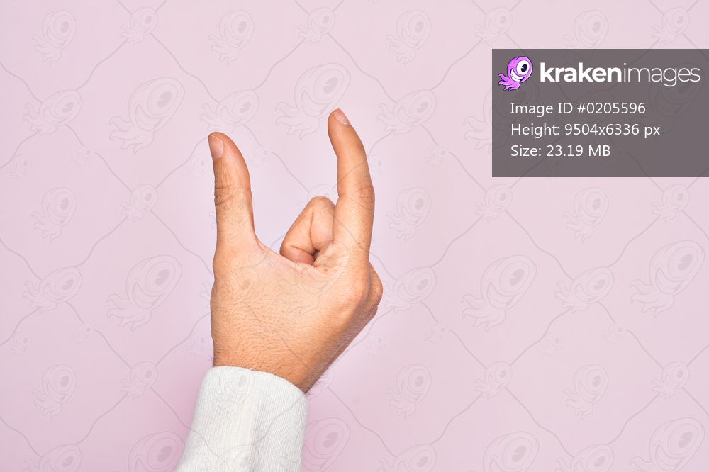 Hand of caucasian young man showing fingers over isolated pink background picking and taking invisible thing, holding object with fingers showing space