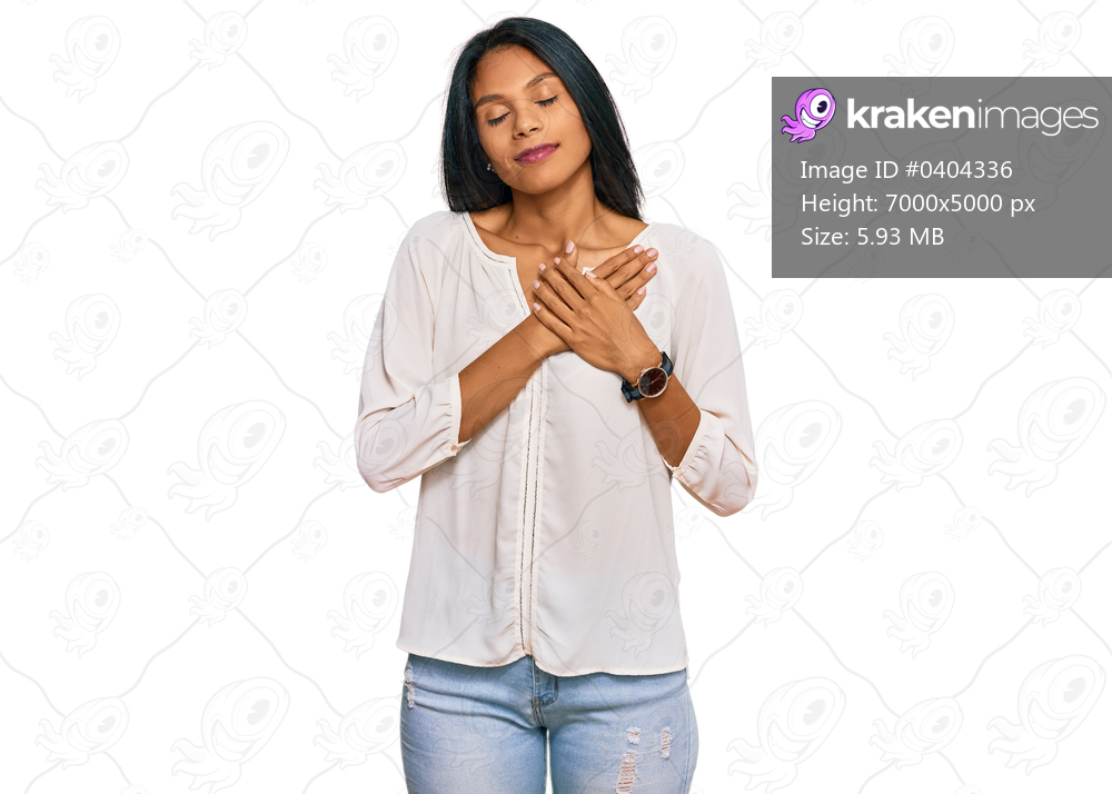 Young african american woman wearing casual clothes smiling with hands on chest with closed eyes and grateful gesture on face. health concept. 
