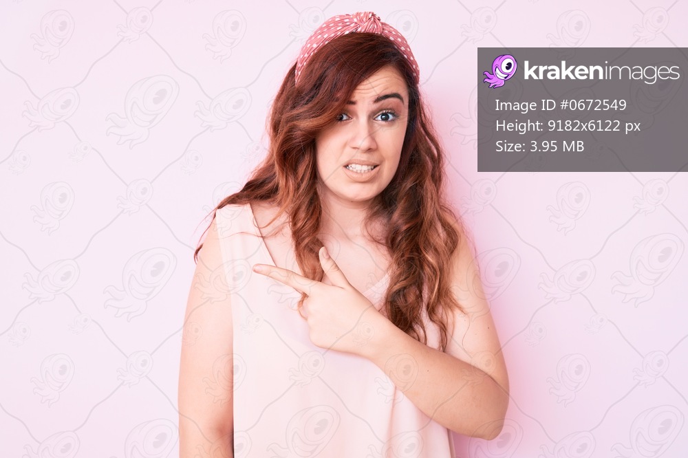 Young beautiful woman wearing casual clothes pointing aside worried and nervous with forefinger, concerned and surprised expression 