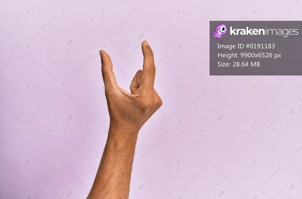 Arm and hand of caucasian young man over pink isolated background picking and taking invisible thing, holding object with fingers showing space 