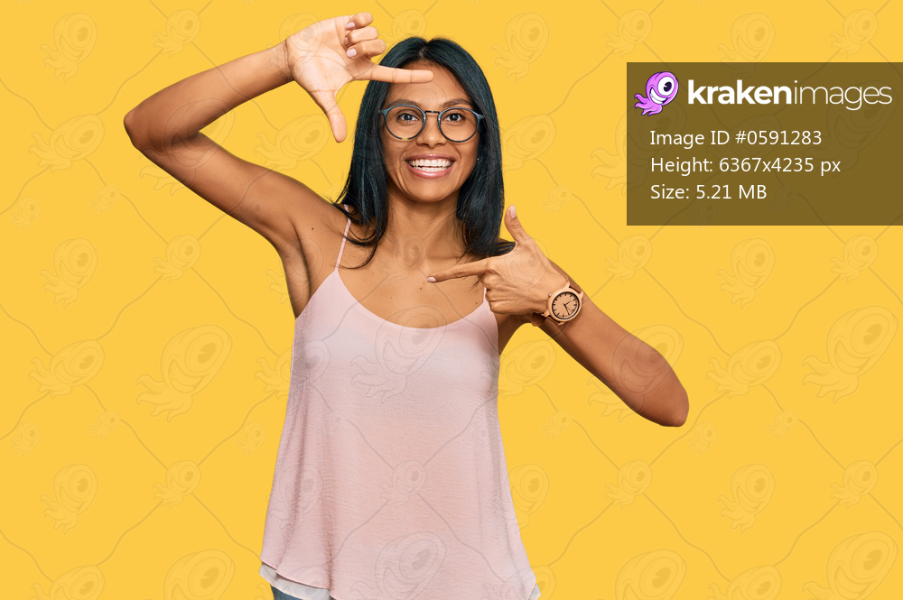 Young african american woman wearing casual clothes and glasses smiling making frame with hands and fingers with happy face. creativity and photography concept. 