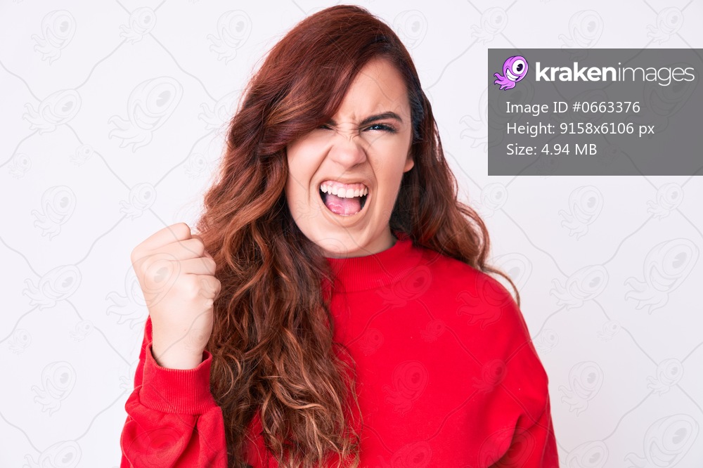 Young beautiful woman wearing casual clothes angry and mad raising fist frustrated and furious while shouting with anger. rage and aggressive concept. 