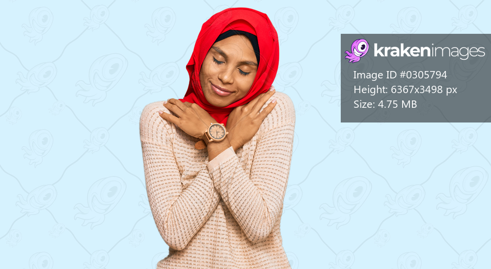 Young african american woman wearing traditional islamic hijab scarf hugging oneself happy and positive, smiling confident. self love and self care 