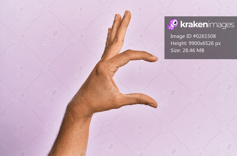 Arm and hand of caucasian young man over pink isolated background picking and taking invisible thing, holding object with fingers showing space 