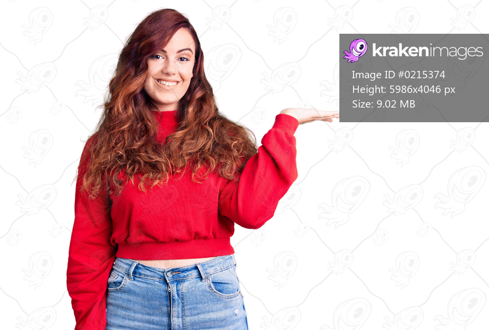 Young beautiful woman wearing casual winter sweater smiling cheerful presenting and pointing with palm of hand looking at the camera. 