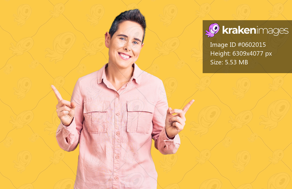 Young woman with short hair wearing casual clothes smiling confident pointing with fingers to different directions. copy space for advertisement 