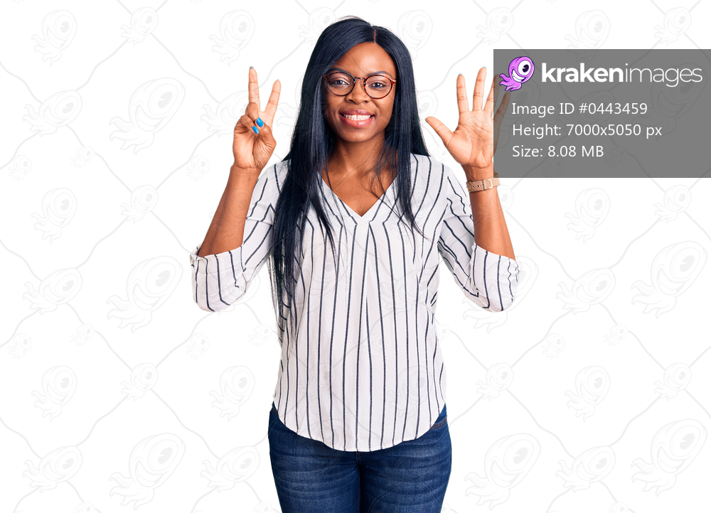Young african american woman wearing casual clothes and glasses showing and pointing up with fingers number seven while smiling confident and happy. 