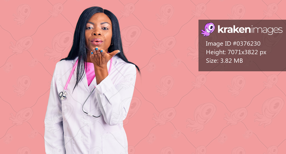 Young african american woman wearing doctor stethoscope looking at the camera blowing a kiss with hand on air being lovely and sexy. love expression. 