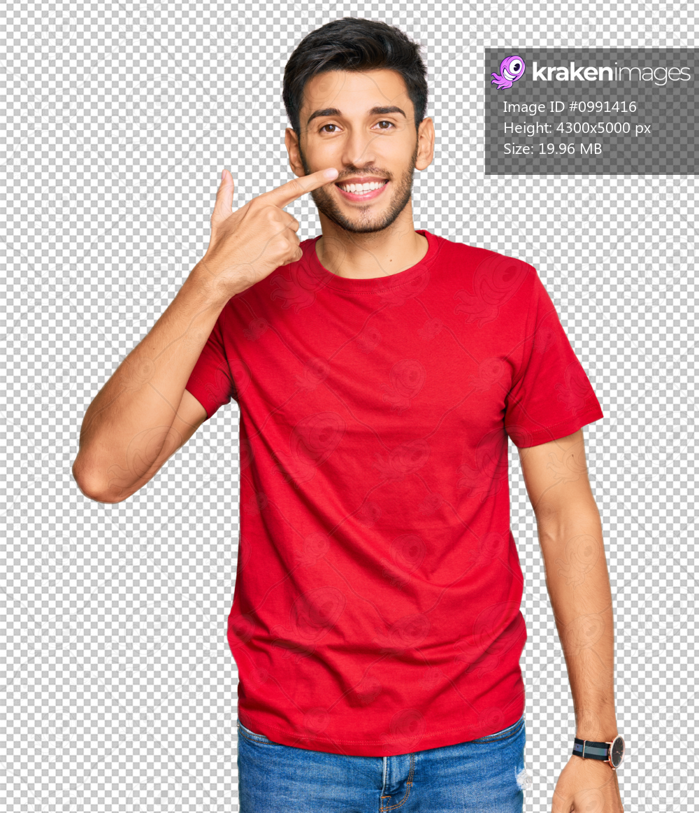 Young handsome man wearing casual red tshirt pointing with hand finger to face and nose, smiling cheerful. beauty concept