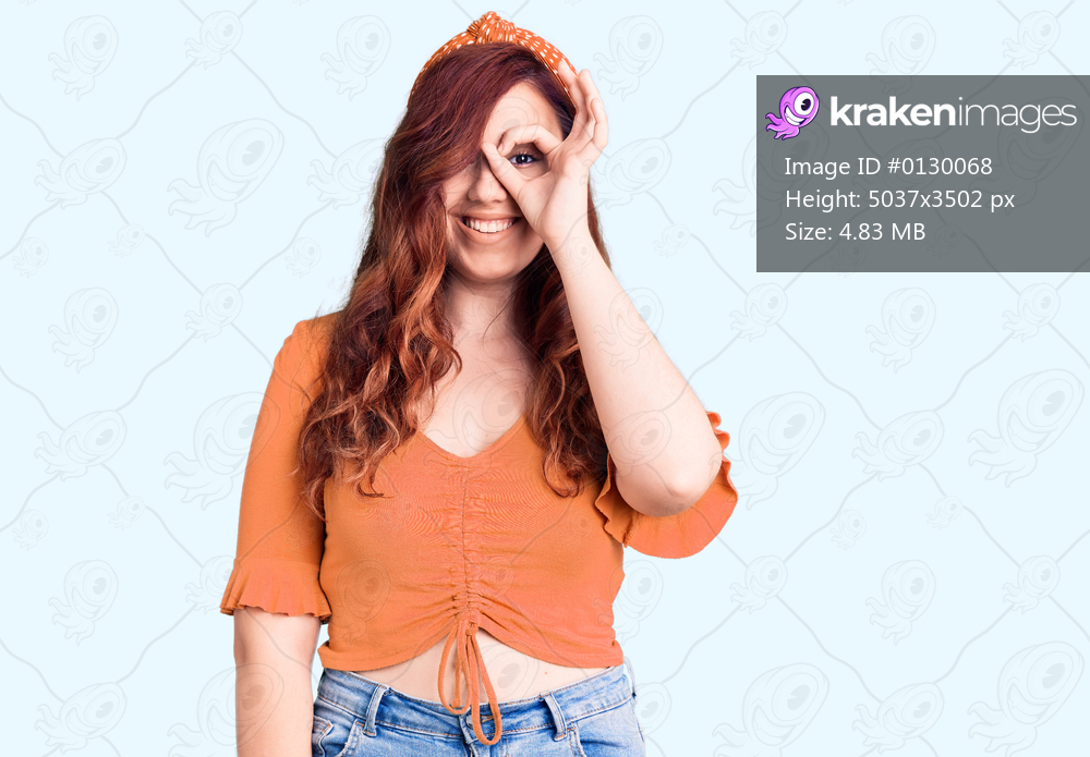Young beautiful woman wearing casual clothes smiling happy doing ok sign with hand on eye looking through fingers 