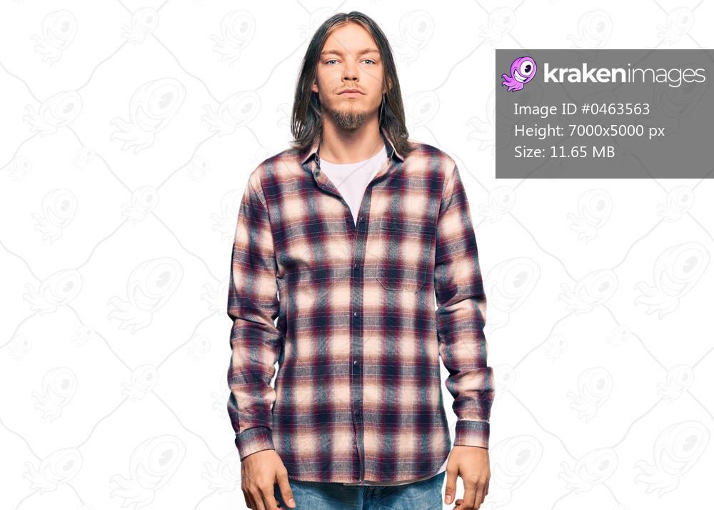 Handsome caucasian man with long hair wearing hipster shirt relaxed with serious expression on face. simple and natural looking at the camera. 