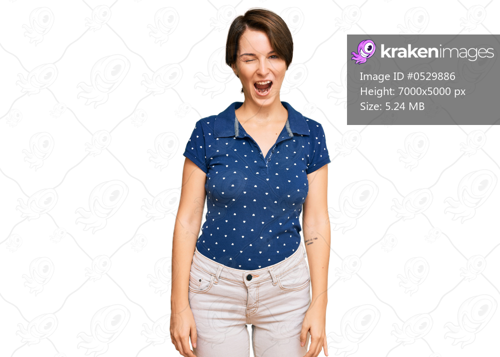 Young brunette woman with short hair wearing casual clothes winking looking at the camera with sexy expression, cheerful and happy face. 