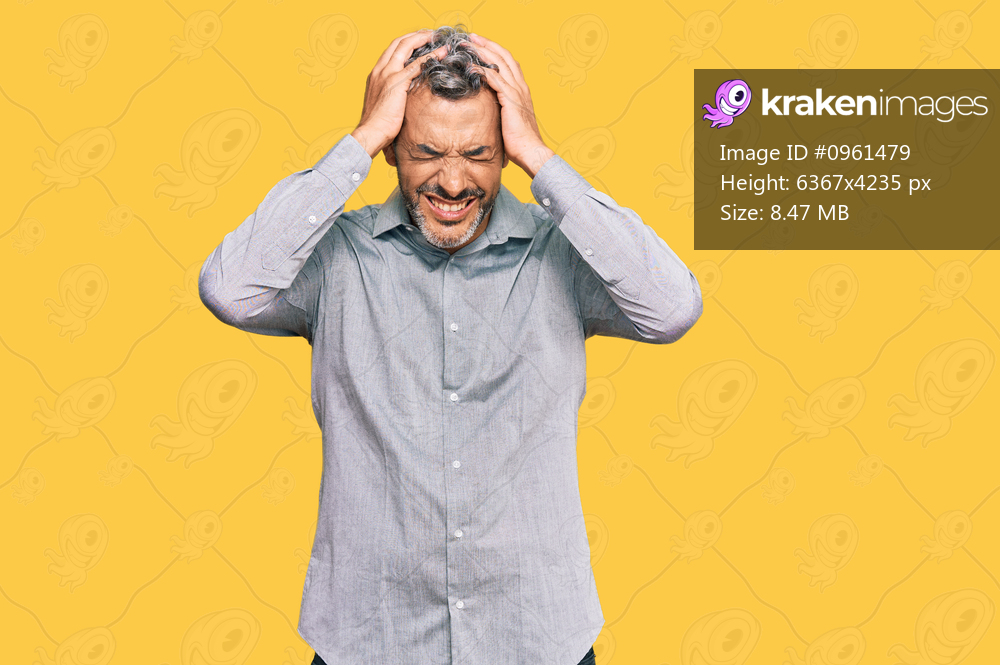 Middle age grey-haired man wearing casual clothes suffering from headache desperate and stressed because pain and migraine. hands on head. 