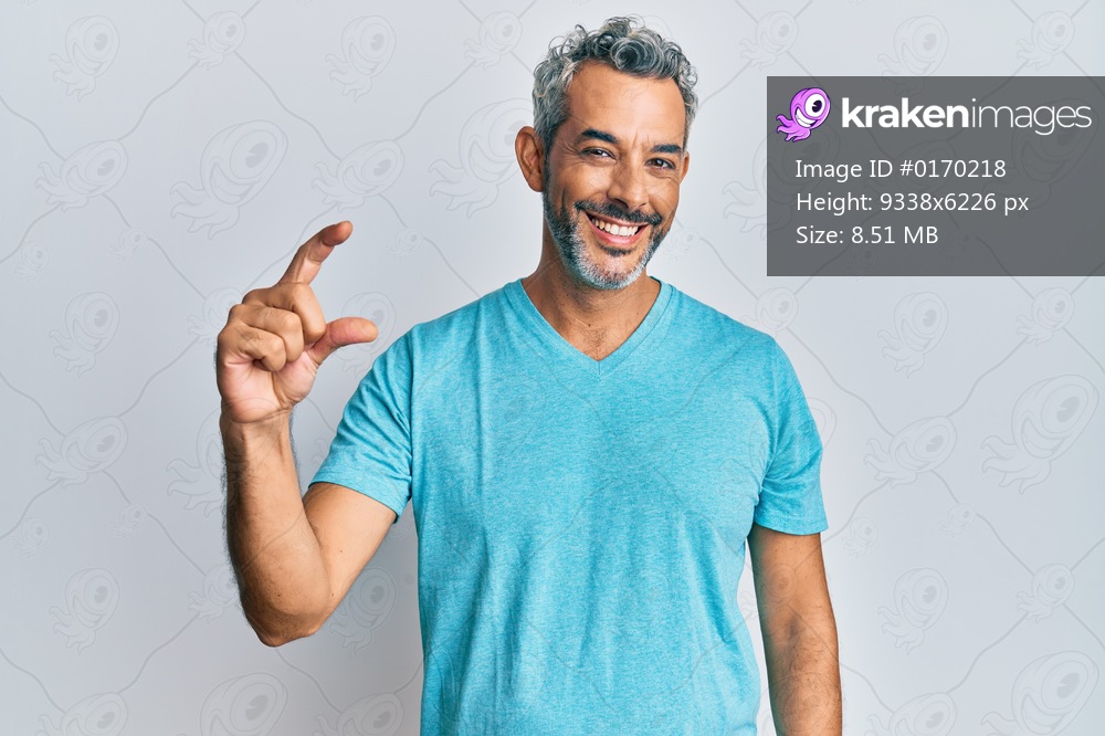 Middle age grey-haired man wearing casual clothes smiling and confident gesturing with hand doing small size sign with fingers looking and the camera. measure concept. 