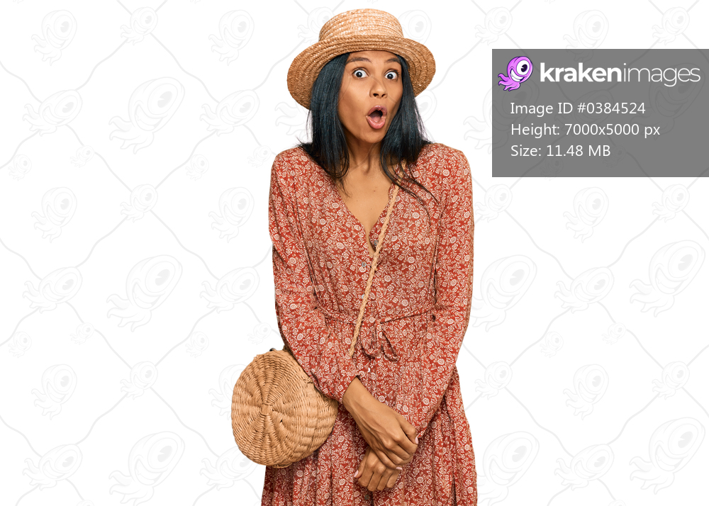 Young african american woman wearing summer hat afraid and shocked with surprise expression, fear and excited face. 