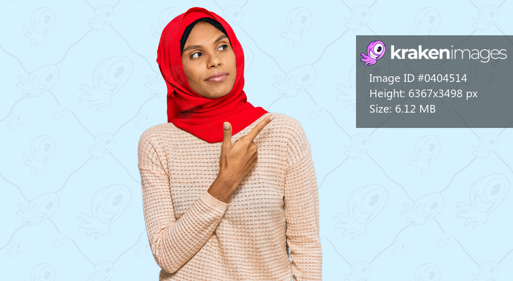 Young african american woman wearing traditional islamic hijab scarf pointing with hand finger to the side showing advertisement, serious and calm face 