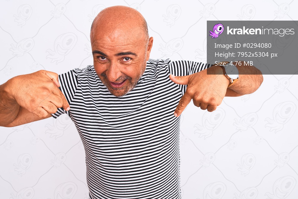 Middle age handsome man wearing striped navy t-shirt over isolated white background looking confident with smile on face, pointing oneself with fingers proud and happy.