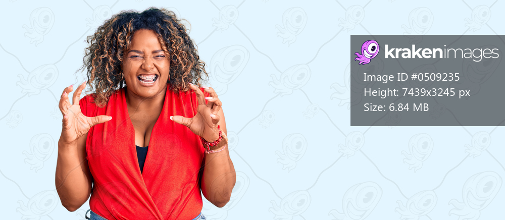 Young african american plus size woman wearing casual style with sleeveless shirt smiling funny doing claw gesture as cat, aggressive and sexy expression 