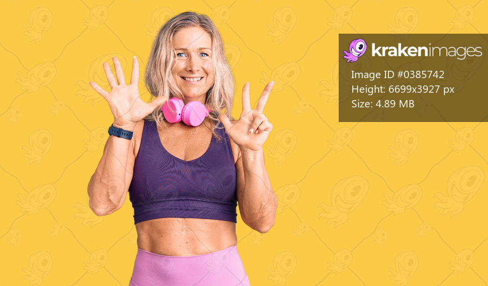 Middle age fit blonde woman wearing gym clothes and using headphones showing and pointing up with fingers number eight while smiling confident and happy. 