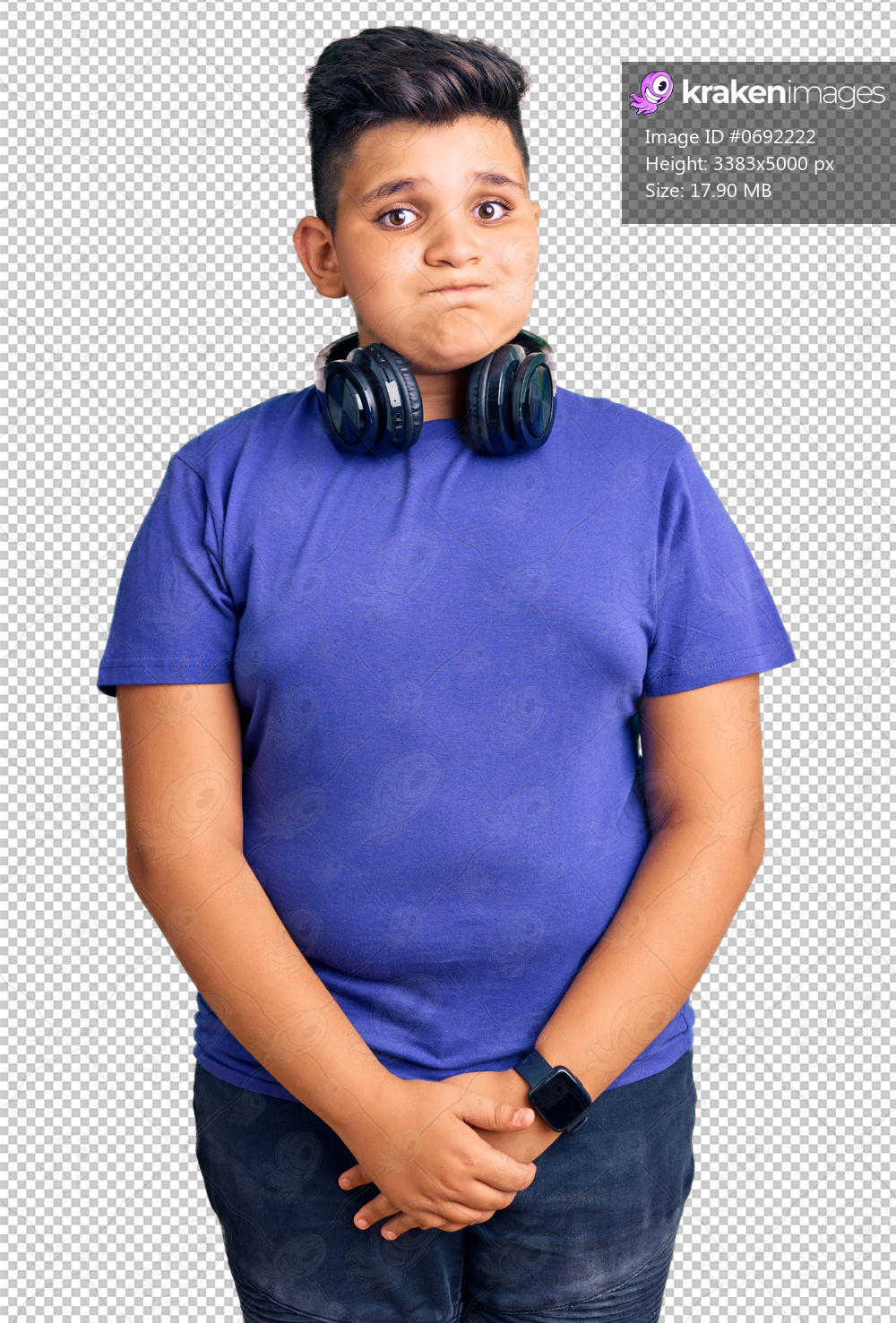 Little boy kid listening to music wearing headphones puffing cheeks with funny face. mouth inflated with air, crazy expression.