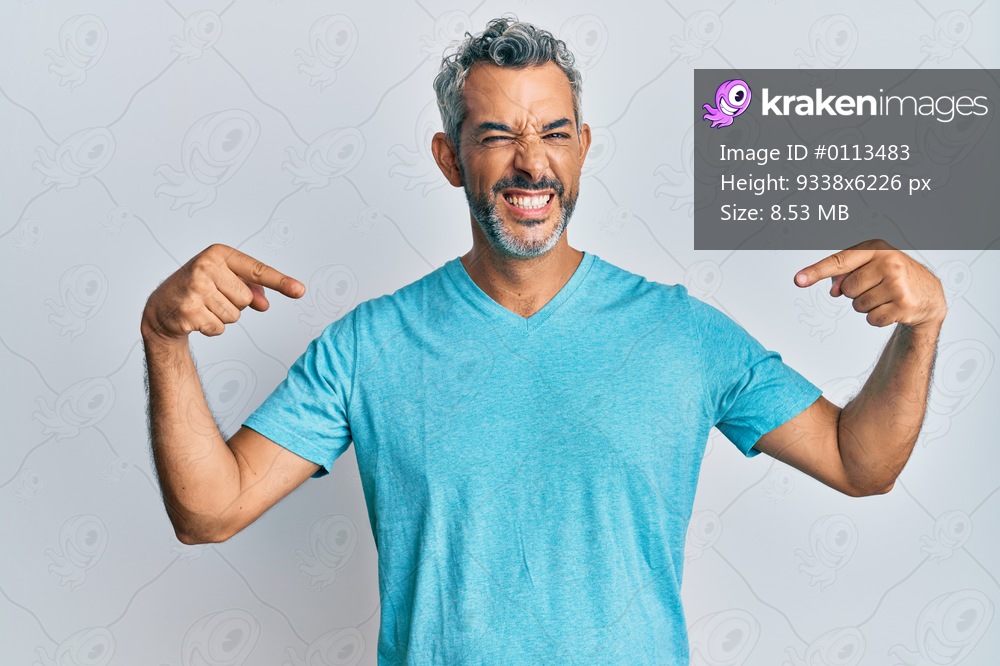 Middle age grey-haired man wearing casual clothes looking confident with smile on face, pointing oneself with fingers proud and happy. 
