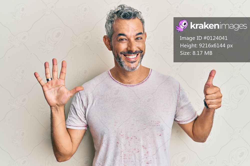 Middle age grey-haired man wearing casual clothes showing and pointing up with fingers number six while smiling confident and happy. 